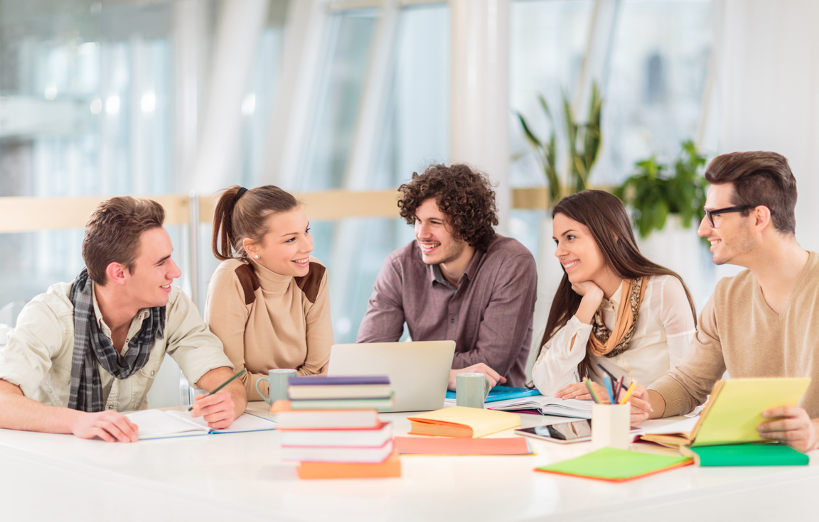 Group of happy students learning together and communicating.